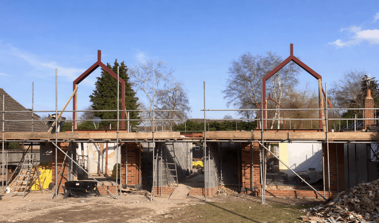 Two-storey extension build with steel apex frames and scaffolding