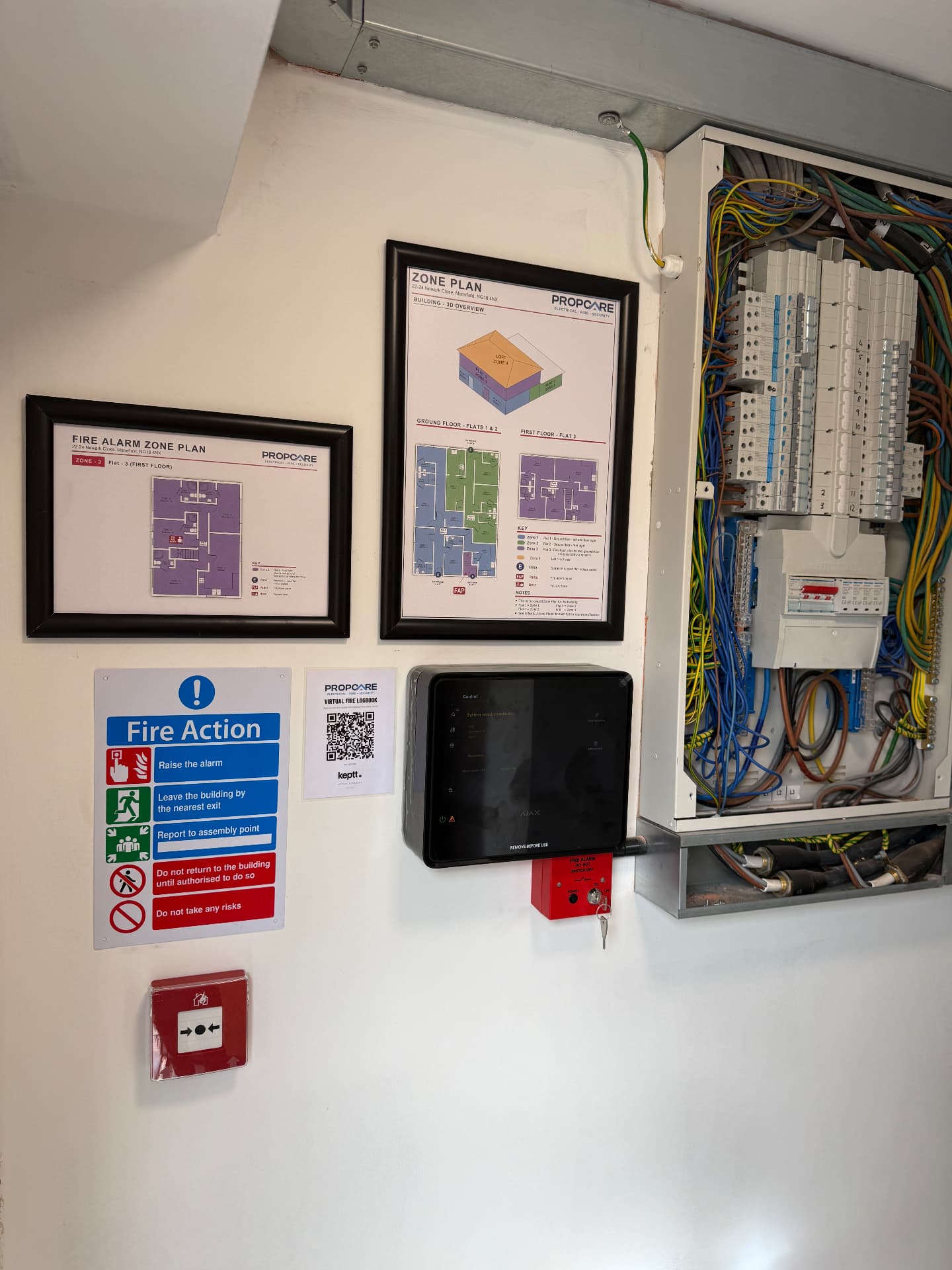 Propcare EFS fire alarm panel, zone plans and fire action signage beside a distribution board
